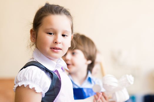 Portrait of Asian girl in apron interested in painting at an art school