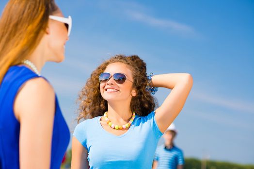 young couple standing on the road, having fun with friends