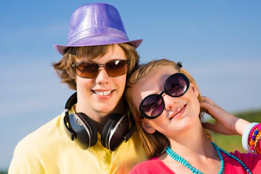 young couple standing on the road, having fun with friends