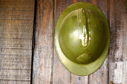 antique soldier helmet hanging on wood wall