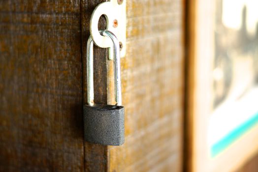 metal master key at wooden door,shallow focus