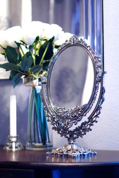 baroque style mirror on wood table,shallow focus
