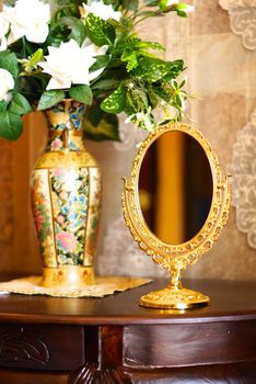 baroque style mirror on wood table,shallow focus