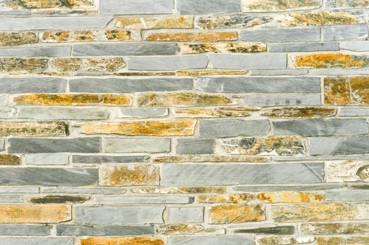 stone wall background of slate and sandstone masonry