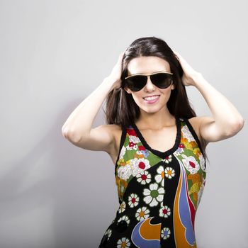 Happy young brunette woman with sun glasses against white background, Fashion portrait