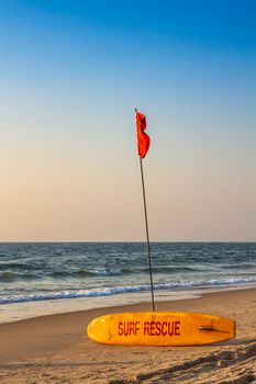 Rescue surfboard on the sand beach near the sea or ocean