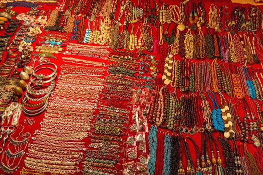Indian imitation jewelry on the counter of street shop. Night Market in Arpora, Goa, India