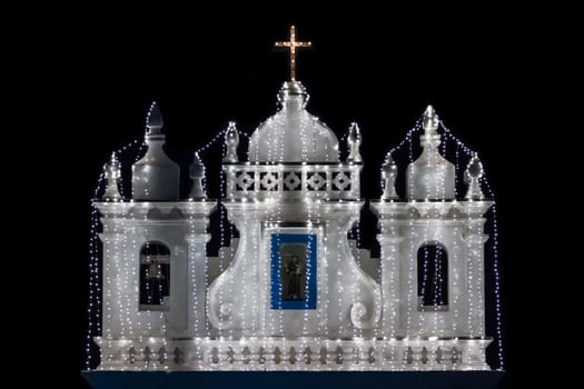 Illuminated church at the night on black background
