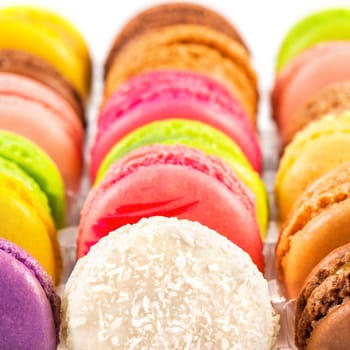 traditional french colorful macarons in a rows in a box