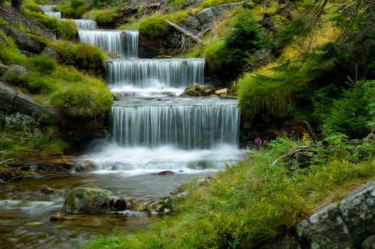 Amazing cascade in a wooded mountainous landscape 