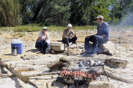 Picnic in walk for friends who have decided to enjoy the first days of spring in the French Cevennes region along the Gardon River in the department of Gard.