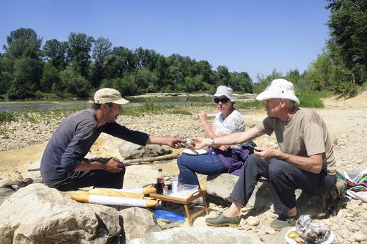 Picnic in walk for friends who have decided to enjoy the first days of spring in the French Cevennes region along the Gardon River in the department of Gard.