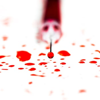 Closeup hypodermic syringe with blood on a white background