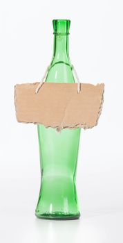 empty wine bottle with cardboard sign around neck