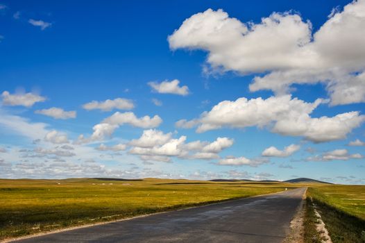 A road at the nature beautiful Hulun prairie in Inner Mongolia, China.