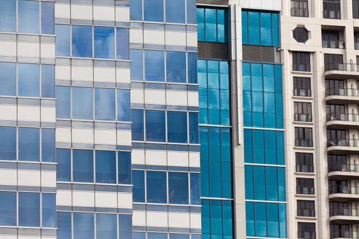 Background pattern of blue window reflections in a modern coporate office building facade