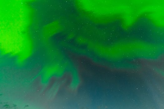 Background texture pattern abstract of green Aurora borealis or northern lights swirls on night sky full of stars