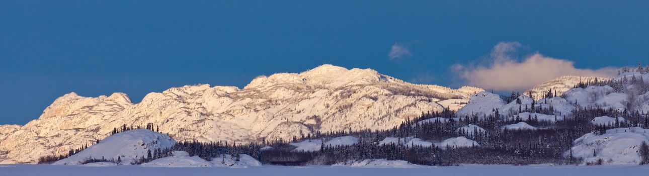 Snow covered boreal forest taiga hills and mountains panorama of Yukon Territory, Canada