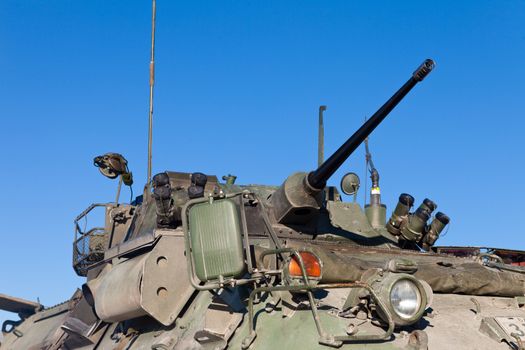 Close up view of the turret, armaments and gun of an operational military armored tank vehicle