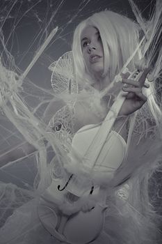 Violin beautiful woman trapped in a spider web, lace dress