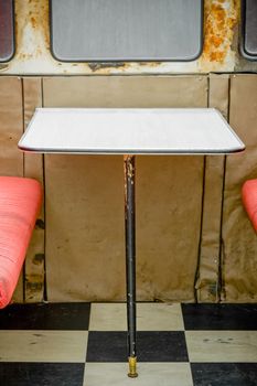 unhygienic diner table with rust around the windows