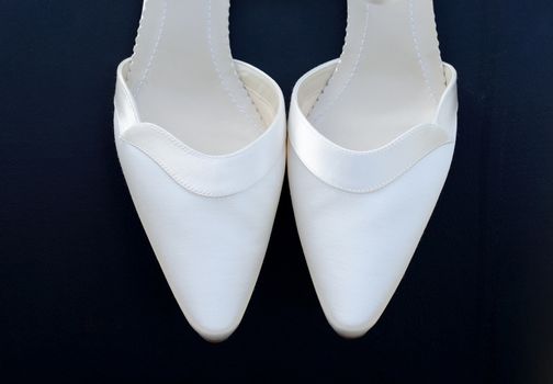 Pair of brides white shoes closeup 