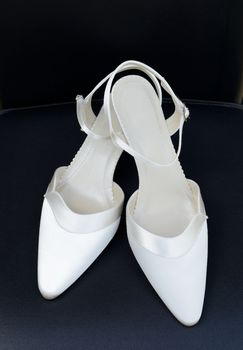 Wedding day pair of white shoes for bride closeup