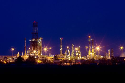 Oil refinery buildings at night