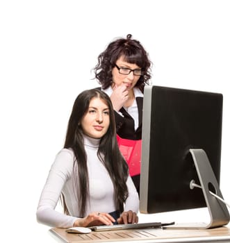 Two business woman in front of computer, isolated