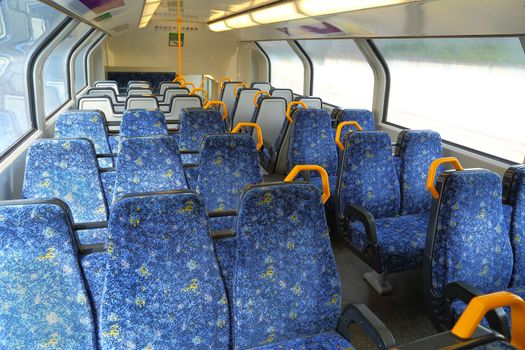 Interior of a passenger train with empty seats