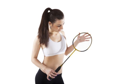 Beautiful girl holding badminton racket isolated on white background. Active healthy lifestyle. 