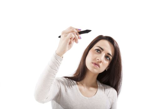 Young beautiful business woman holding black marker and writing on glass board isolated on white. Young woman in business.