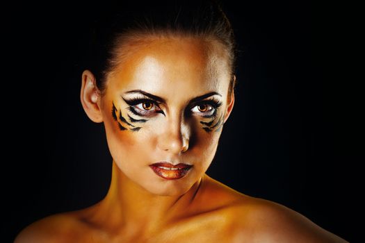 Beautiful and dangerous girl tigress with predatory gaze close-up portrait