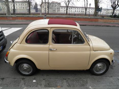 FLORENCE, CIRCA JANUARY 2012 - Fiat 500 by the river Arno in Florence, circa January 2012 