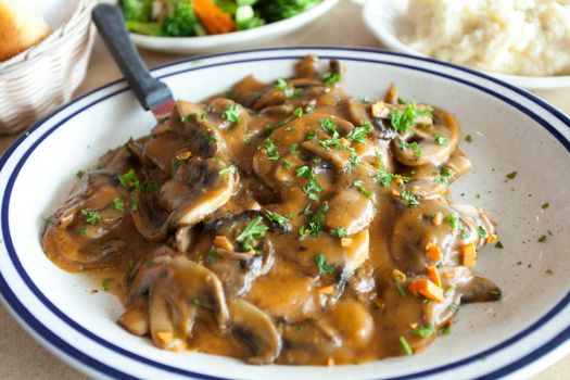 Chicken marsala dish with mashed potatoes and veg.