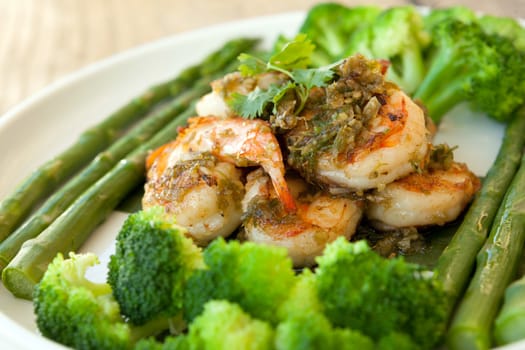 Shrimp scampi seafood dish with broccoli and asparagus.