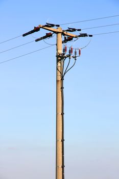 Power lines in front of a blue sky.