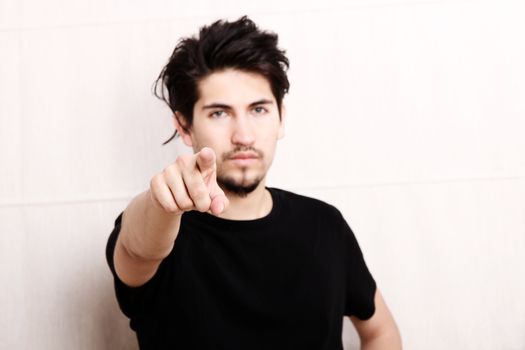 A young man pointing at you.