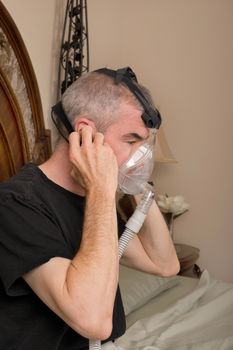 Man wearing his CPAP machine before sleeping