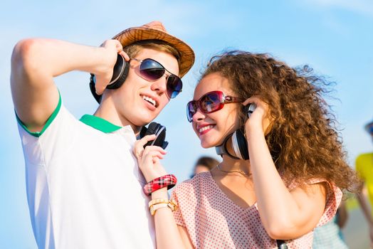 young couple standing on the road, having fun with friends