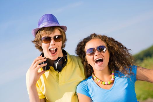 young couple standing on the road, having fun with friends