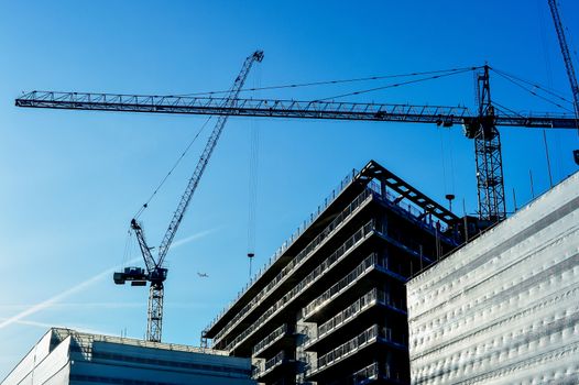 Construction site with cranes on sky background