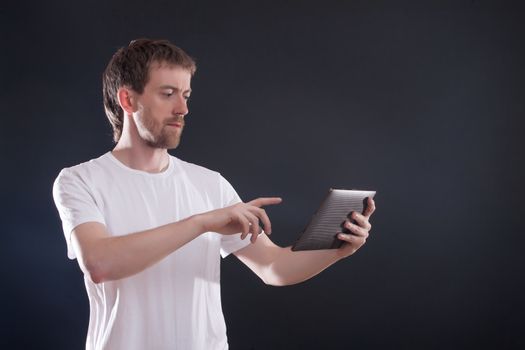 Portrait man with digital tablet on black background