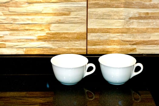 couple of coffee cups on black marble table,shallow focus