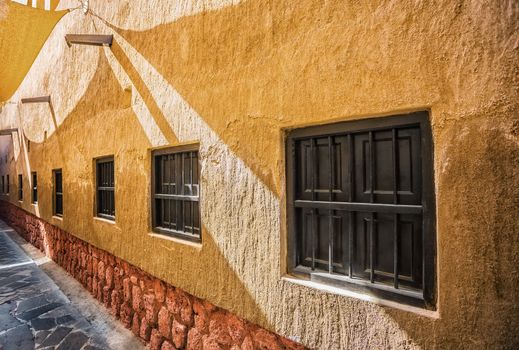 Old window on the ancient wall of eastern city