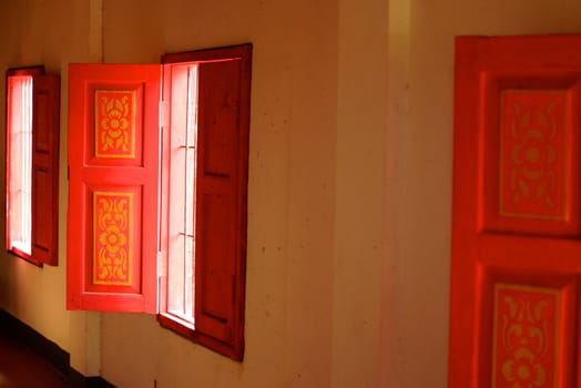 wood window was painted thai pattern with red and gold colours,Lampang temple,Thailand