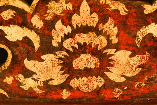 the detail of  thai gold painting pattern on ancient  wood plate,shallow focus,Lampang temple,Thailand