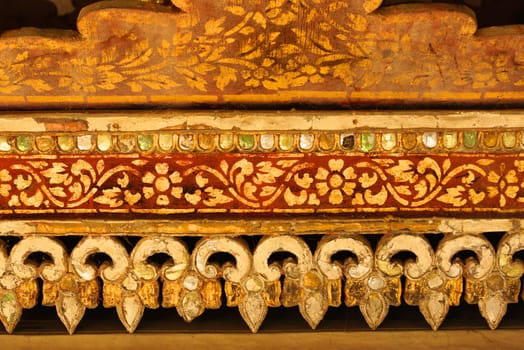 the detail of  thai gold painting pattern on ancient  wood plate,shallow focus,Lampang temple,Thailand