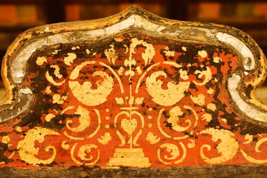 the detail of  thai gold painting pattern on ancient  wood plate,shallow focus,Lampang temple,Thailand