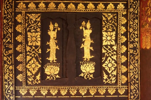 the detail of  thai gold painting pattern on ancient  wood plate,shallow focus,Lampang temple,Thailand